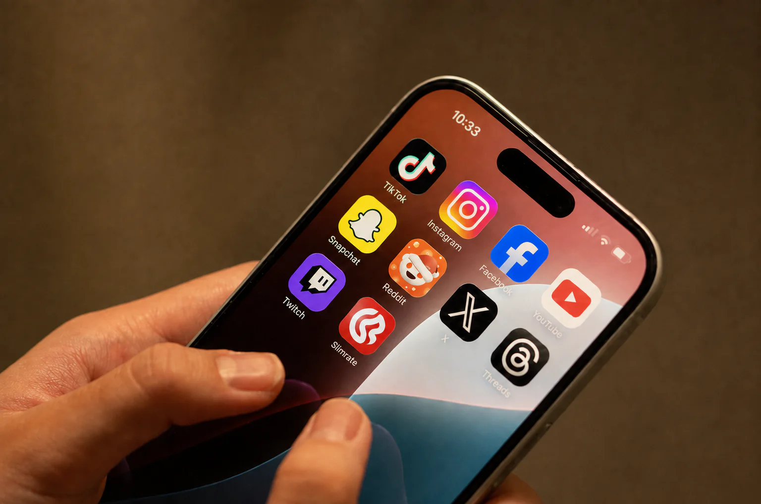 Hand holding a smartphone with the Slimrate mobile app icon on screen